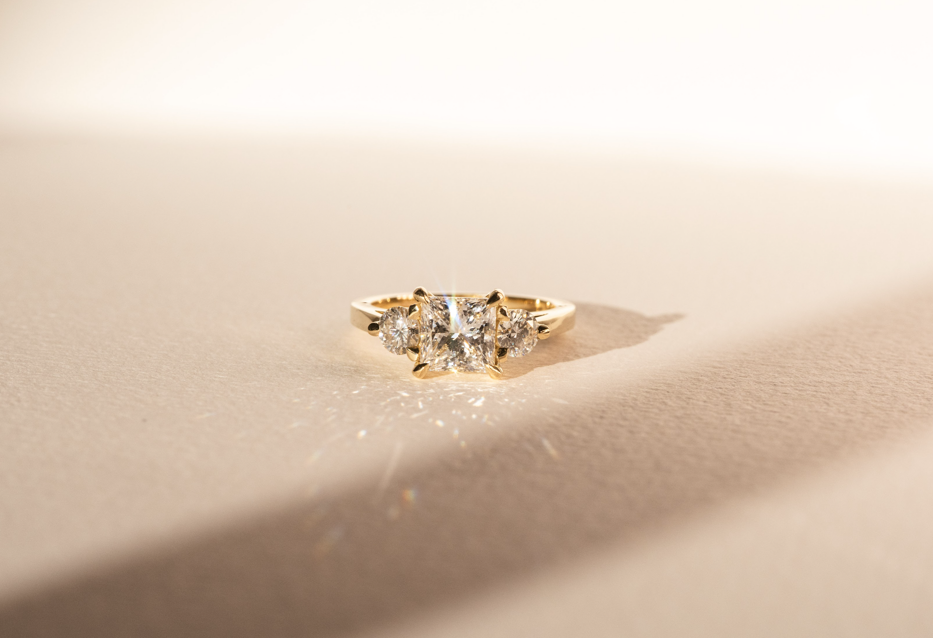 Three Stone Diamond Ring Princess Cut with Round Diamond Side Stones - Bespoke Design
